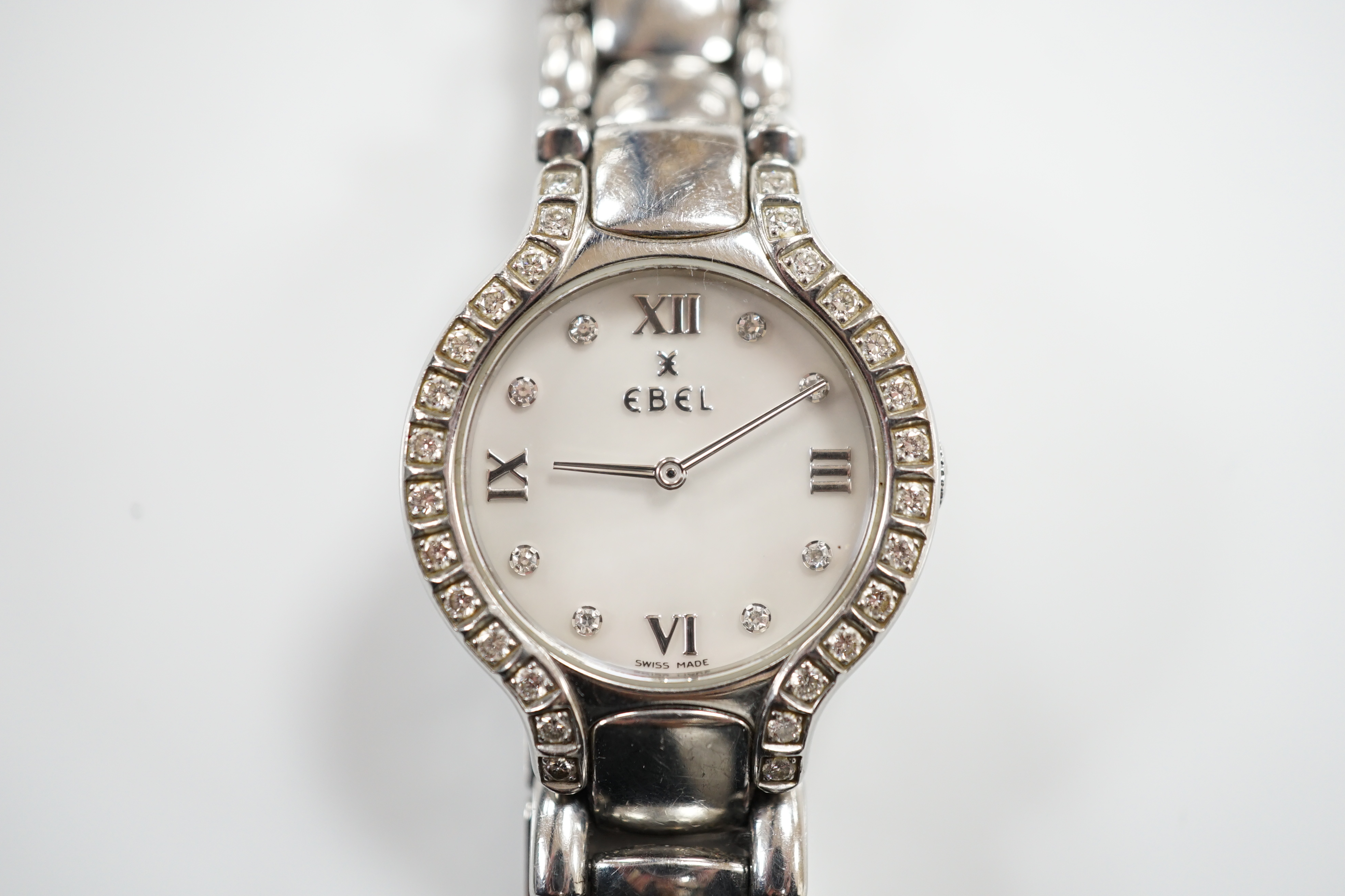 A lady's 2001 stainless steel Ebel quartz wrist watch, with diamond set bezel, mother of pearl dial and diamond dot markers, on a stainless steel bracelet, with box and guarantee.